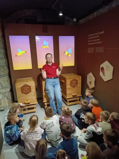 Przedszkolaki słuchają opowieści o życiu pszczół i ich roli w przyrodzie.